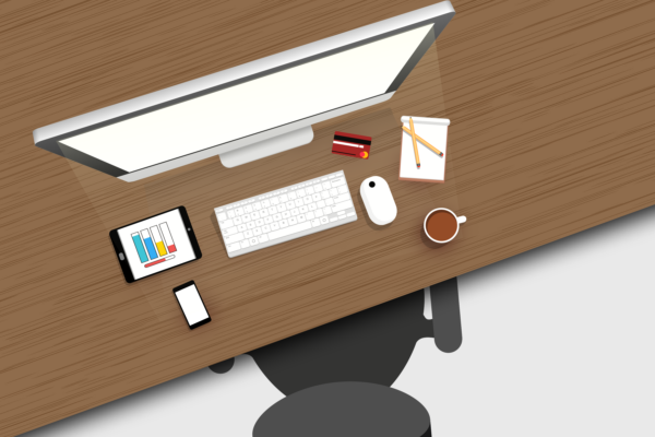 Desktop working from home showing a computer, tablet and mobile devices